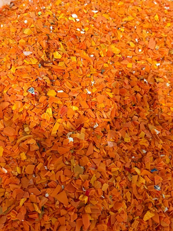 Orange plastic flakes during material sorting
